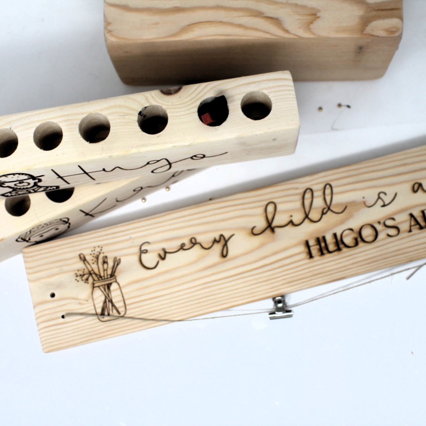 Wooden blocks with engraved text and designs on a white background