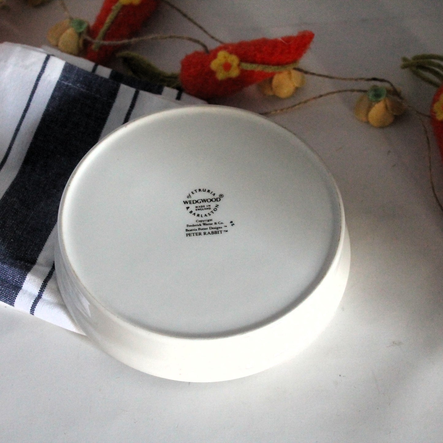 Bottom of a Wedgewood porcelain plate for children on a wite background