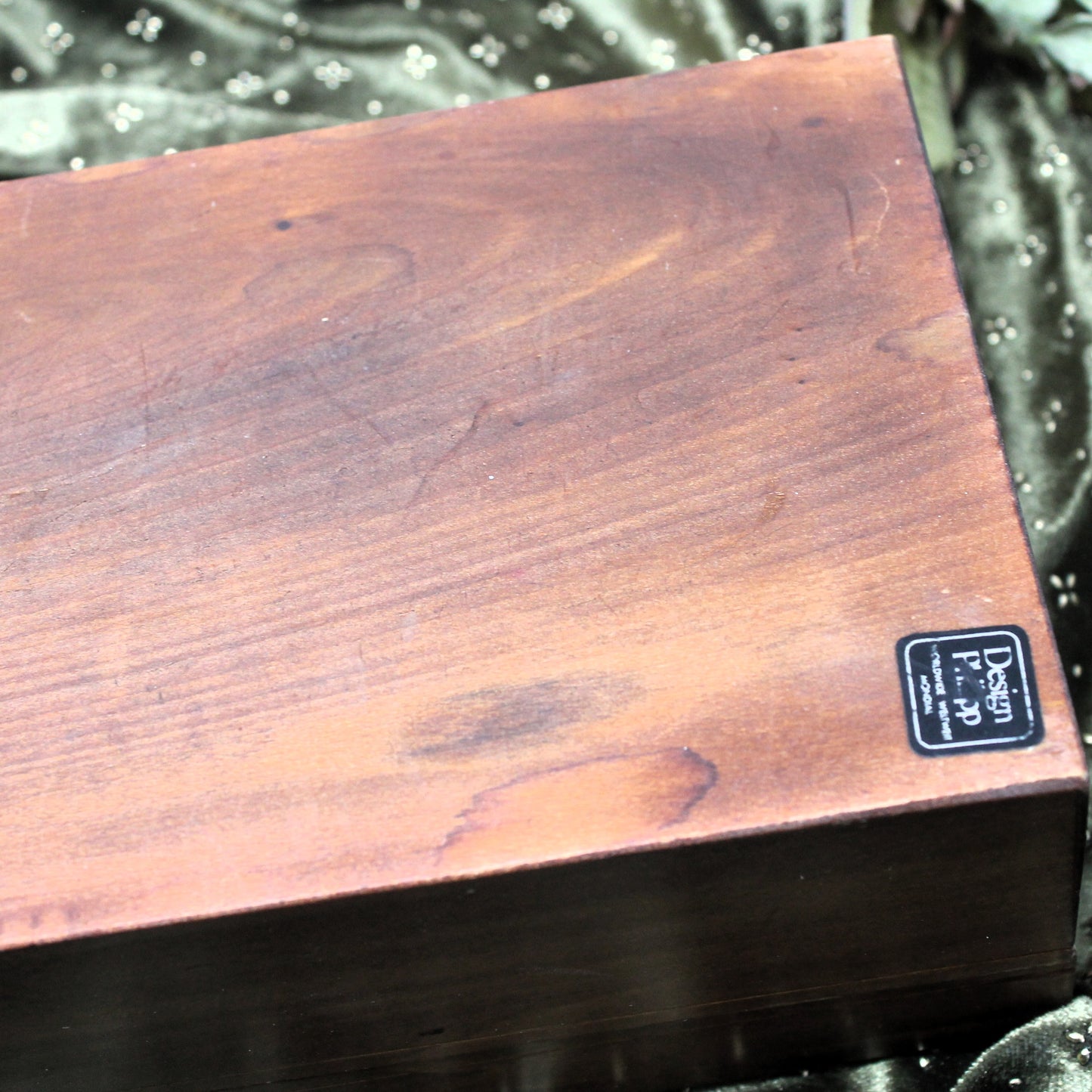 Wooden box with a Philipp Worldwide brand label on a dark background