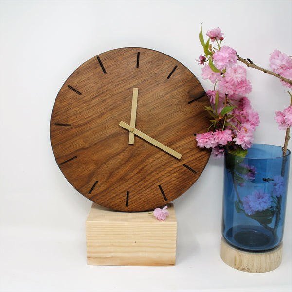 dark wood round wall clock with baton marks and gold hands
