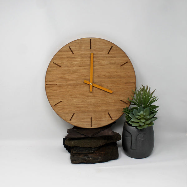 round wooden oak clock with batons marks and yellow metal hands