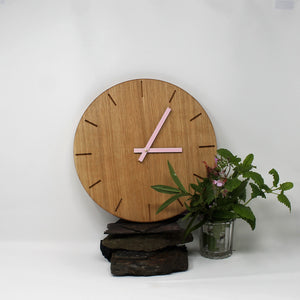 Solid oak round wall clock with baton marks and pink metallic hands