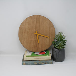 analog blank wooden clock with no numbers and yellow hands