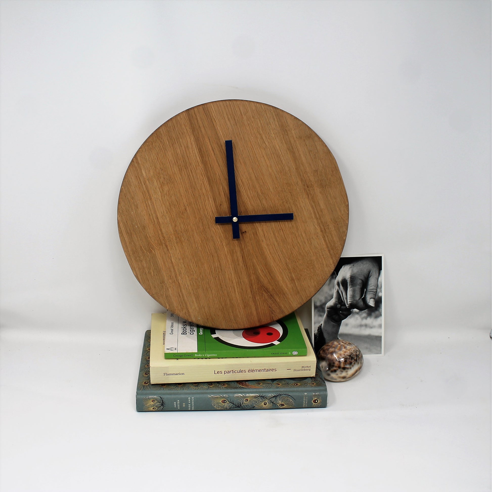 blank analog clock made of oak with nany blue metal hands