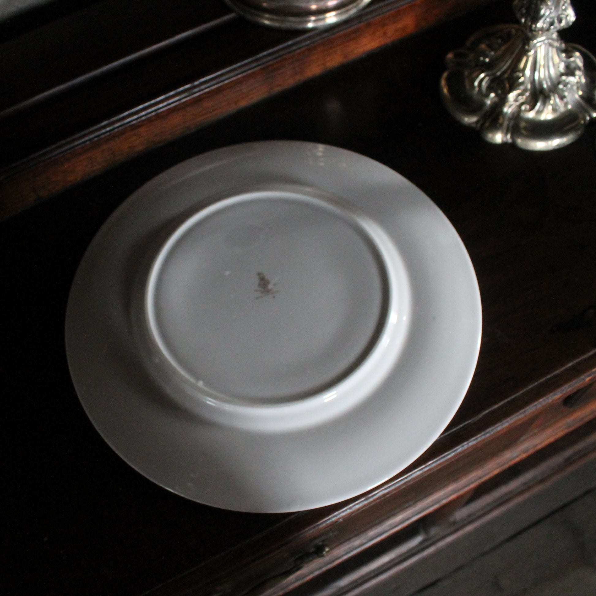 Back of a Royal Doulton Biltmore China plate on a wooden dresser