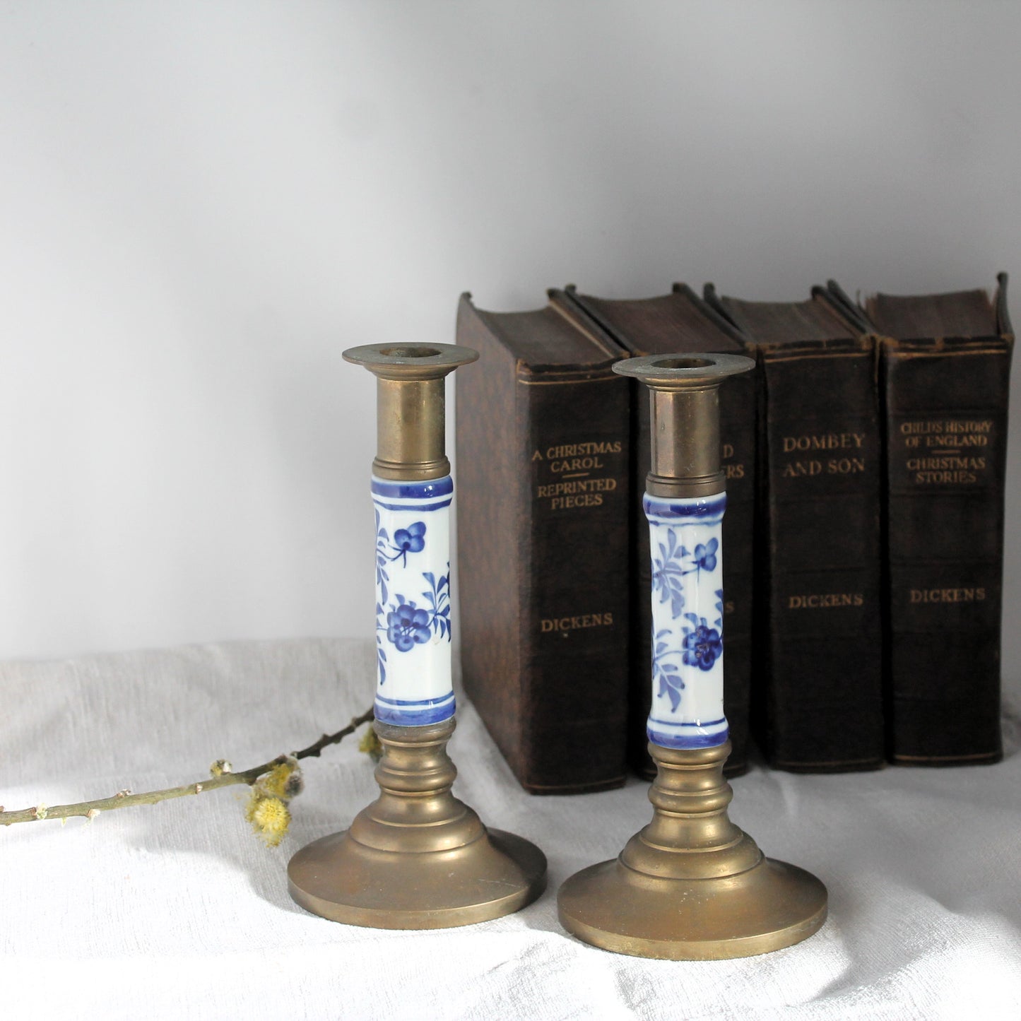vintage brass candlesticks with books in the background