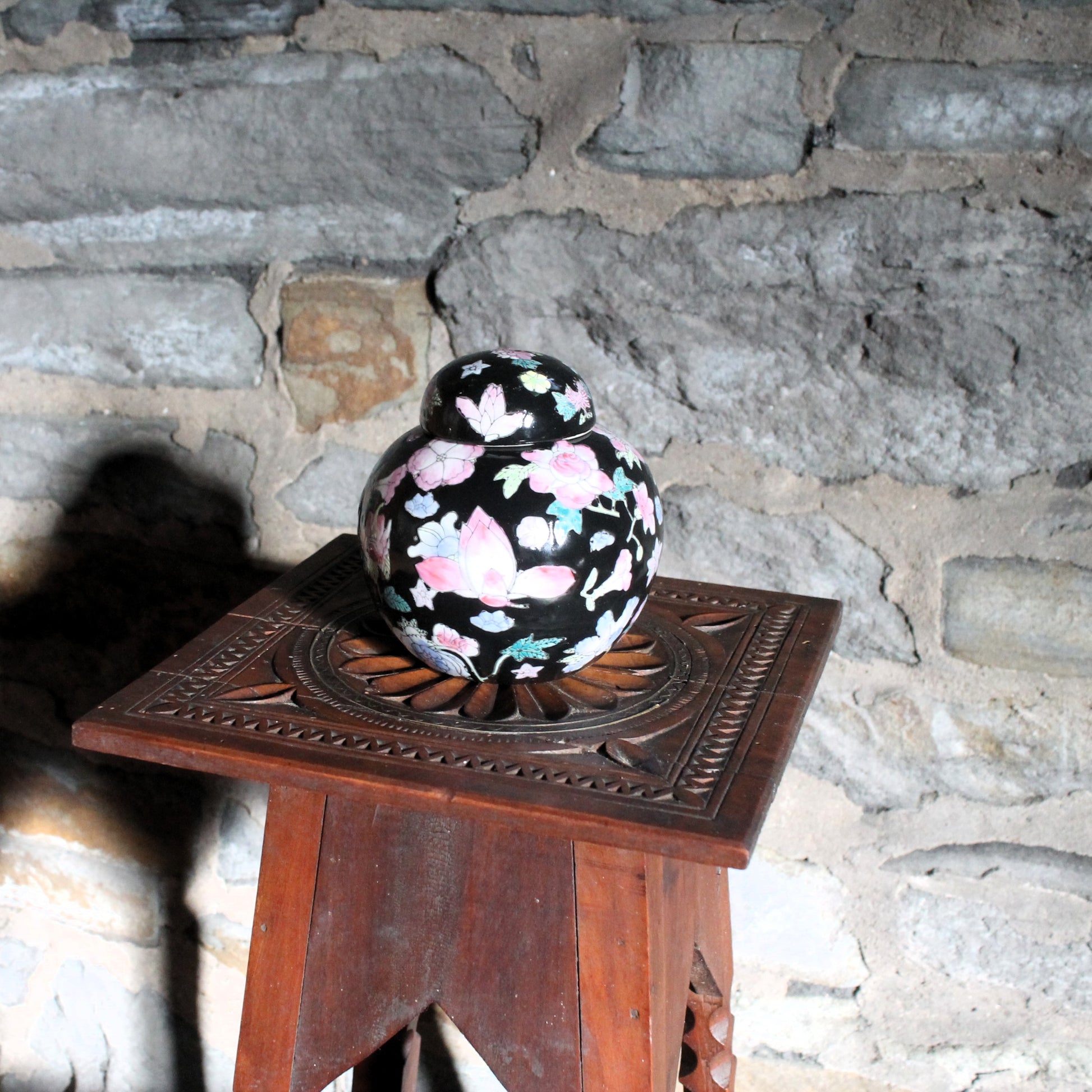 small chinese floral ginger jar on a wooden table 