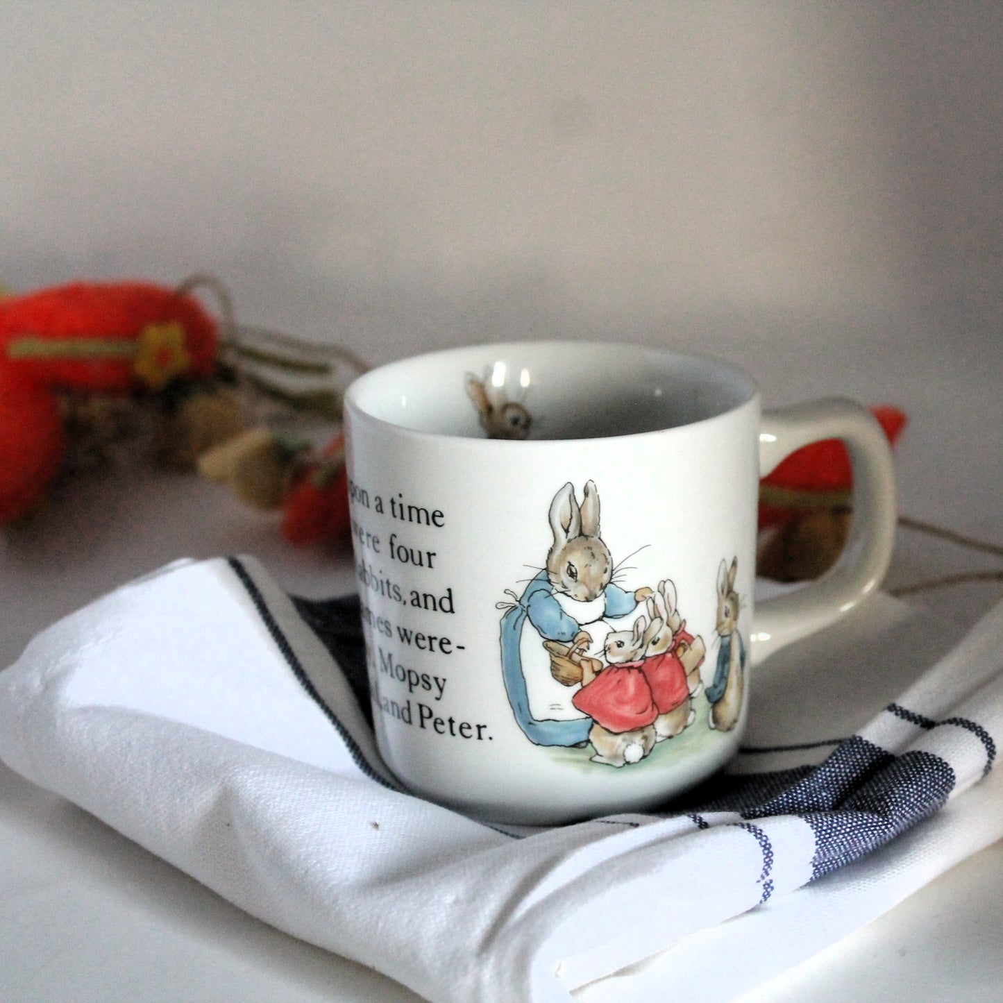 Beatrix Potter china mug for children resting on a tea-towel