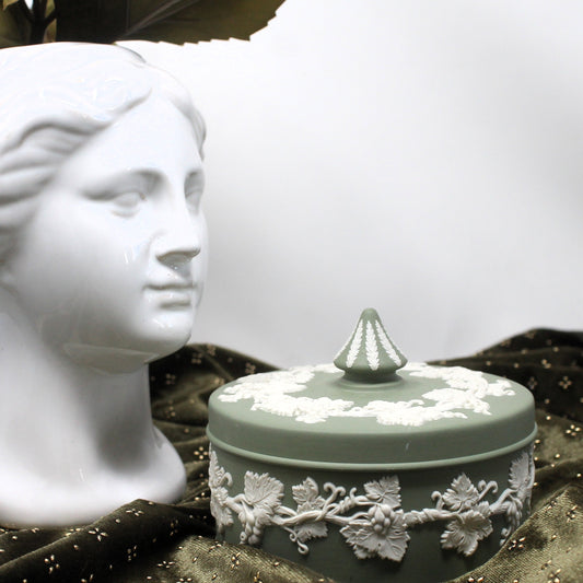 Classic Wedgewood jasper box with lid on a dark cloth with a bust