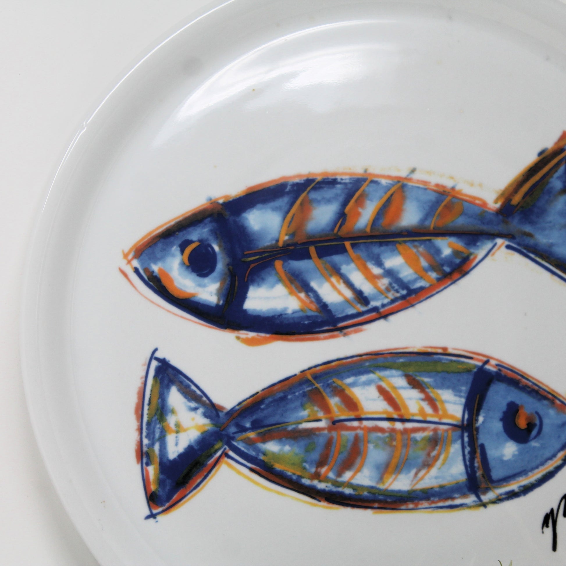 Collectible Italian ceramic plate with an illustration of two blue fish